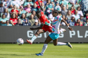 KC's Temwa Chawinga battles San Diego's Naomi Girma for the ball in an NWSL match.