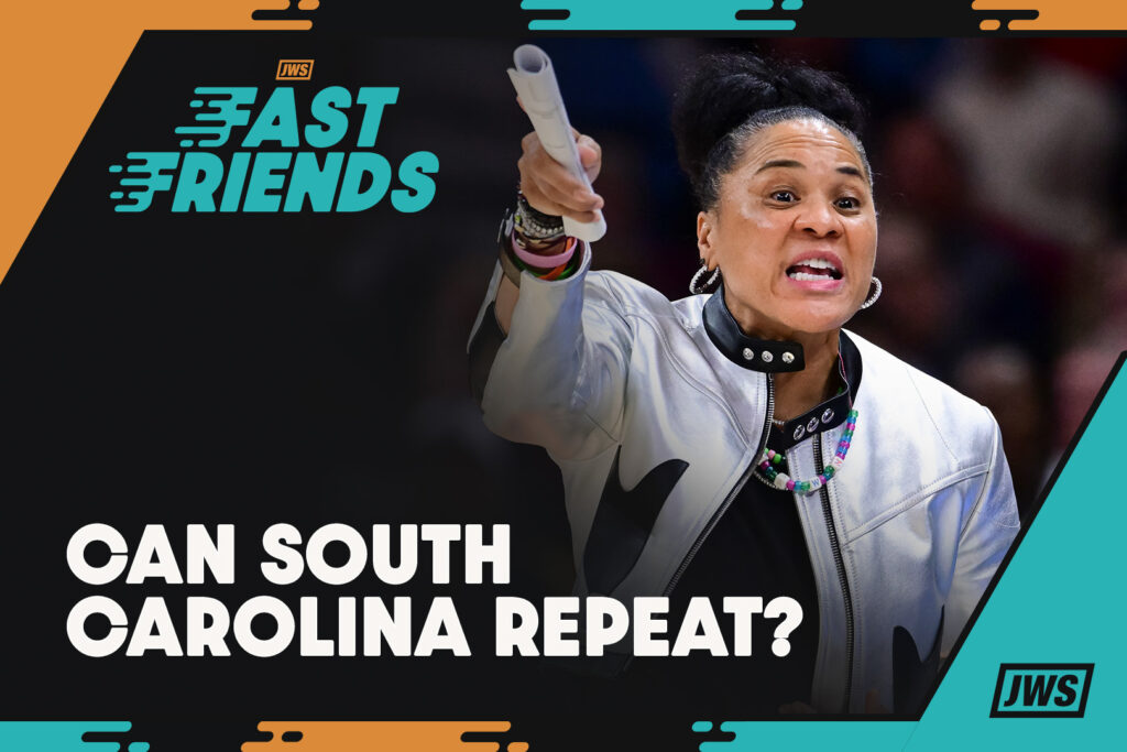 South Carolina head coach Dawn Staley behind the 'Fast Friends' logo