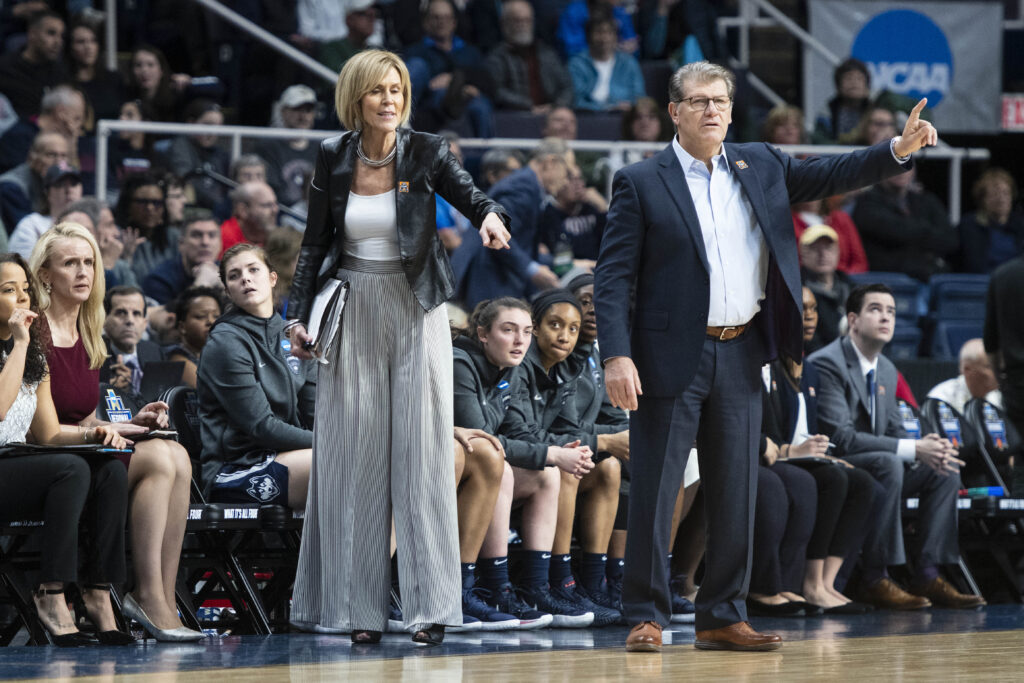 UConn head coach Geno Auriemma and his longtime associate head coach Chris Dailey give instructions on the sideline.