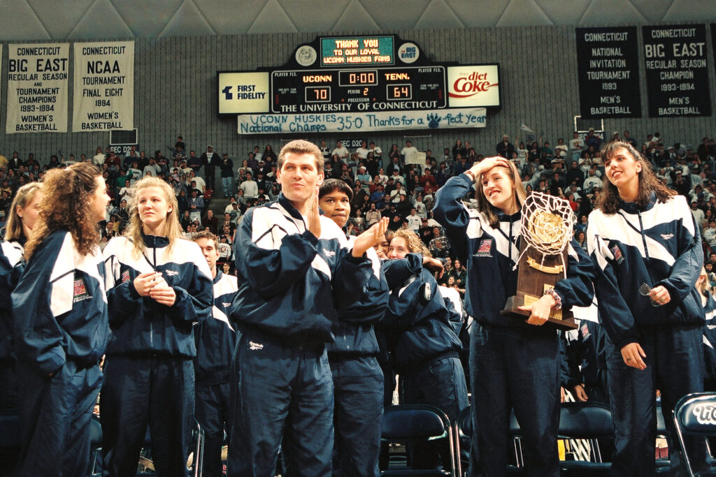 The 1995 UConn team celebrates their first-ever national championship at a pep rally.