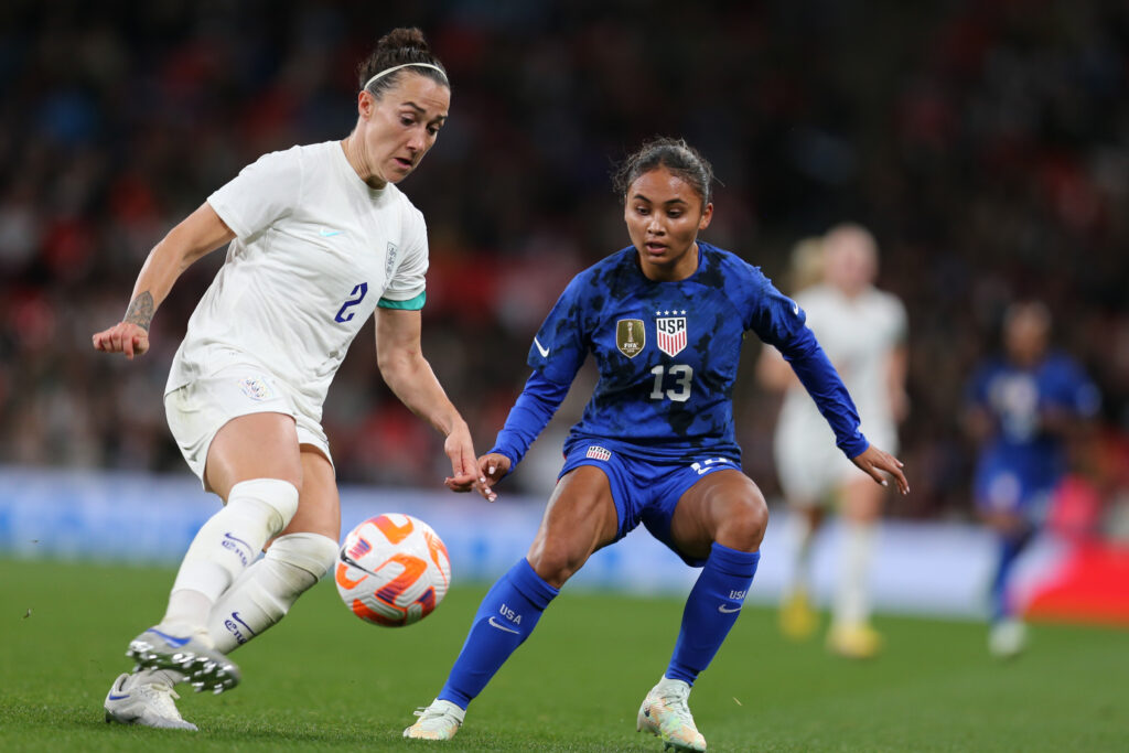 England defender Lucy Bronze tries to dribble past USWNT forward Alyssa Thompson during their 2022 match at Wembley.