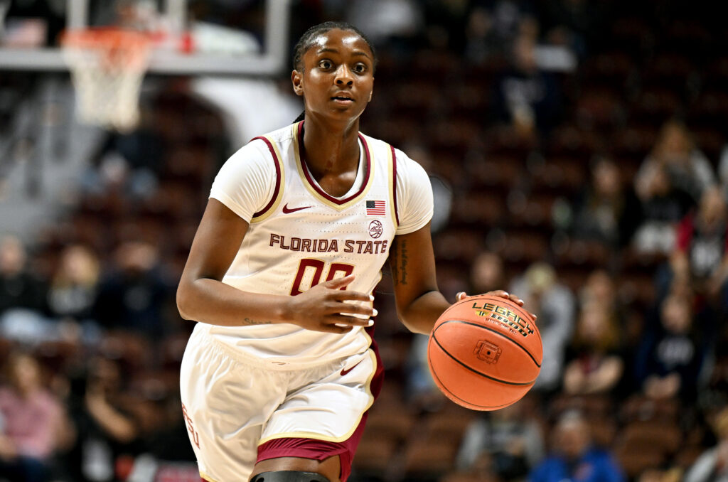 Florida State junior guard Ta'Niya Latson dribbles the ball up the court in an NCAA college basketball game.