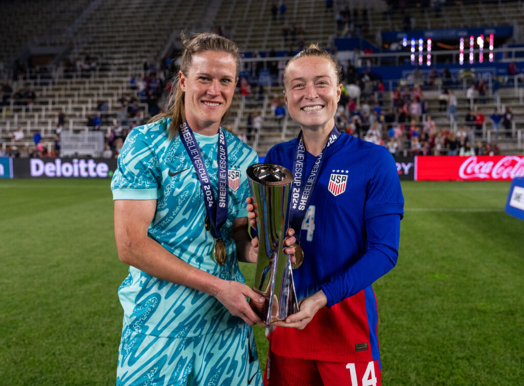 USWNT goalkeeper Alyssa Naeher and defender Emily Sonnett pose with the 2024 SheBelieves Cup trophy.