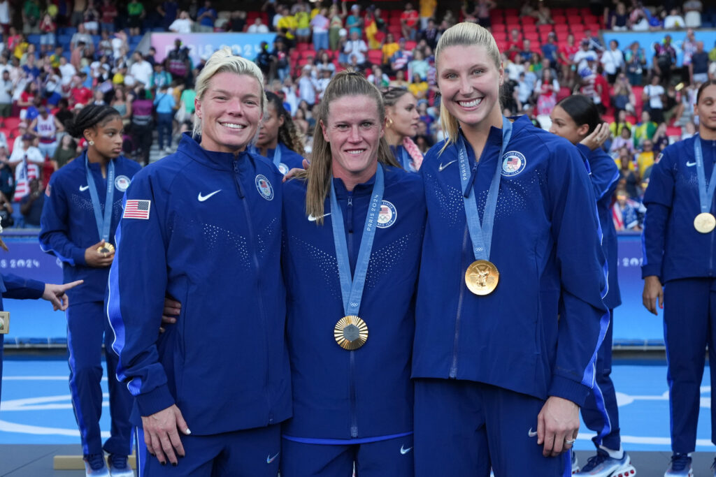 USWNT goalkeepers Jane Campbell, Alyssa Naeher, and Casey Murphy pose at the 2024 Olympics.