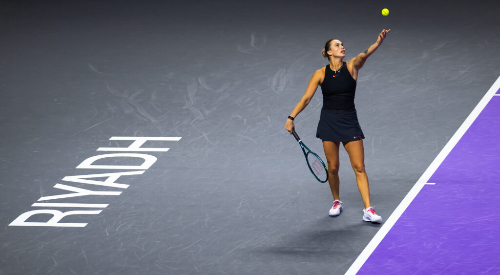 World No. 1 Aryna Sabalenka tosses a serve at the 2024 WTA Finals