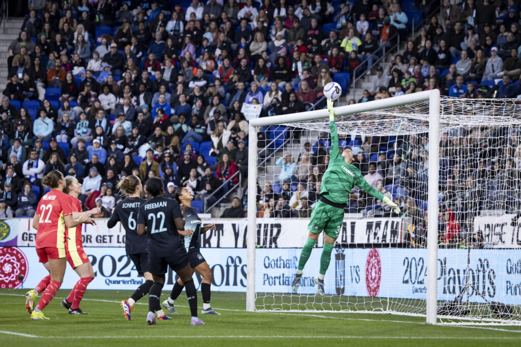 Gotham goalkeeper and 2024 NWSL goalkeeper of the year award winner Ann-Katrin Berger leaps to save a goal during a match.