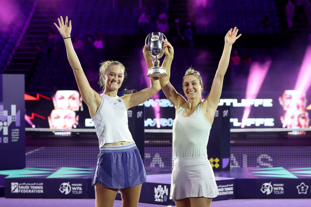 New Zealand's Erin Routliffe and Canada's Gabriela Dabrowski lift their 2024 WTA Finals doubles trophy.