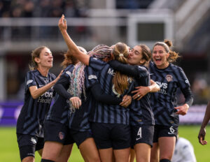 Center back Tara McKeown is mobbed by her Spirit teammates after scoring her first season goal in Sunday's quarterfinal