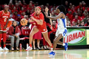 Maryland guard Kaylene Smikle dribbles past Duke's Oluchi Okananwa in an NCAA college basketball game.