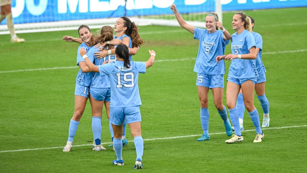 UNC college soccer players celebrate a win.