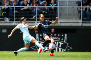 Gotham's Bruninha and Washington's Trinity Rodman battle for the ball during a match.