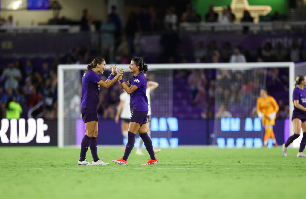 2024 NWSL awards nominees Orlando defenders Kylie Strom and Emily Sams high-five after a win in an NWSL game.