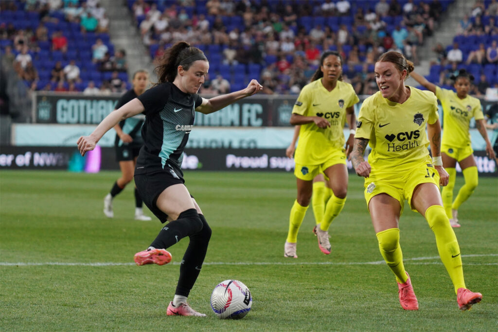 Gotham's Rose Lavelle dribbles around Washington's Hal Hershfelt in an NWSL game.