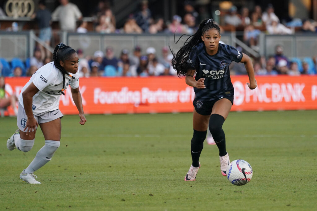 Washington's Croix Bethune dribbles past Bay FC's Kiki Pickett during an NWSL match.