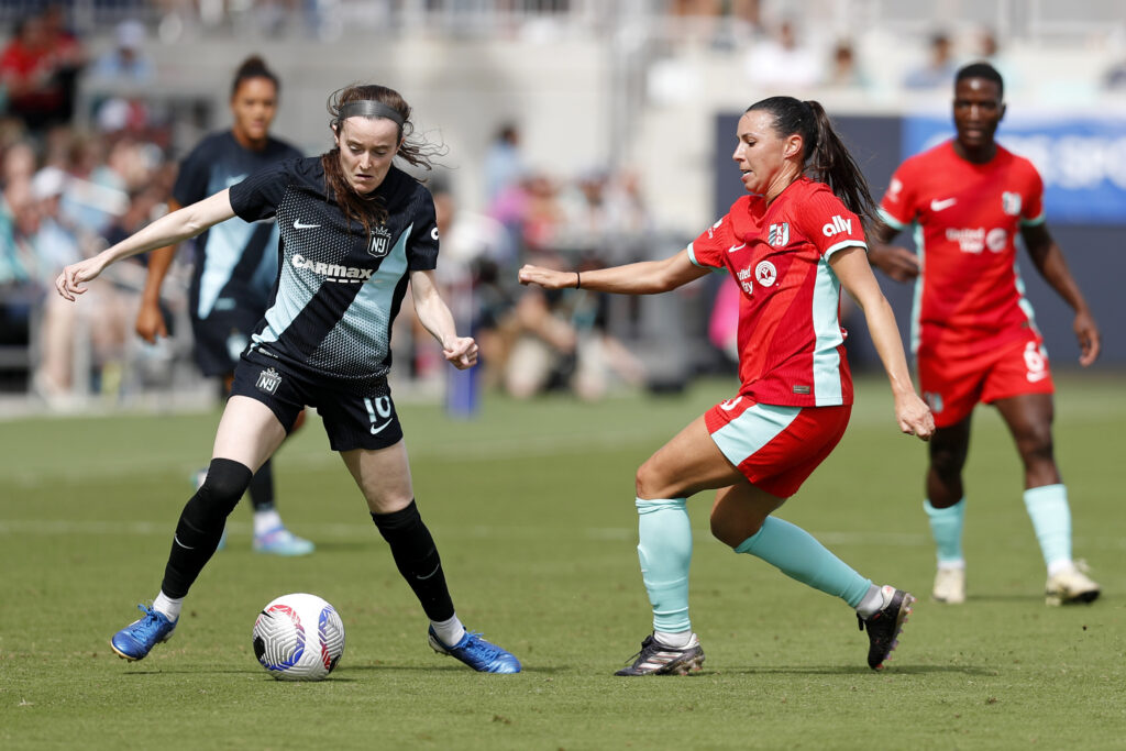 Gotham's Rose Lavelle dribbles around Kansas City's Vanessa DiBernardo during an NWSL match.