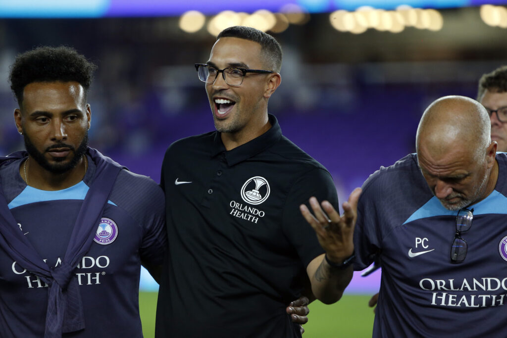 NWSL Coach of the Year finalist and Orlando head coach Seb Hines gives a speech in the team huddle after the 2024 NWSL quarterfinal win.