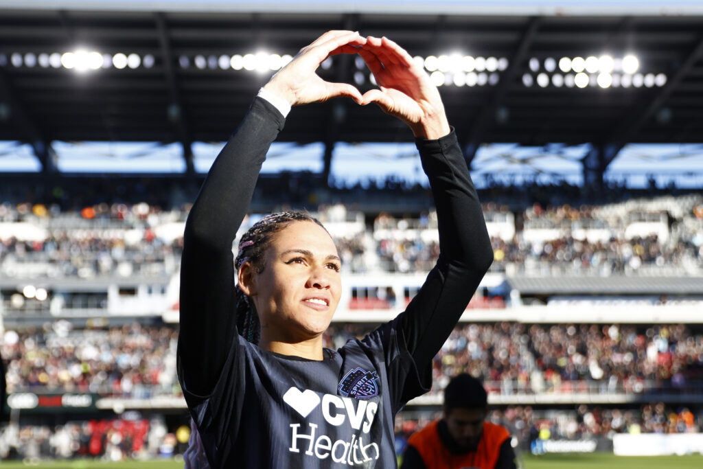 Key NWSL Championship player Spirit forward Trinity Rodman makes a heart sign at fans after an NWSL match.