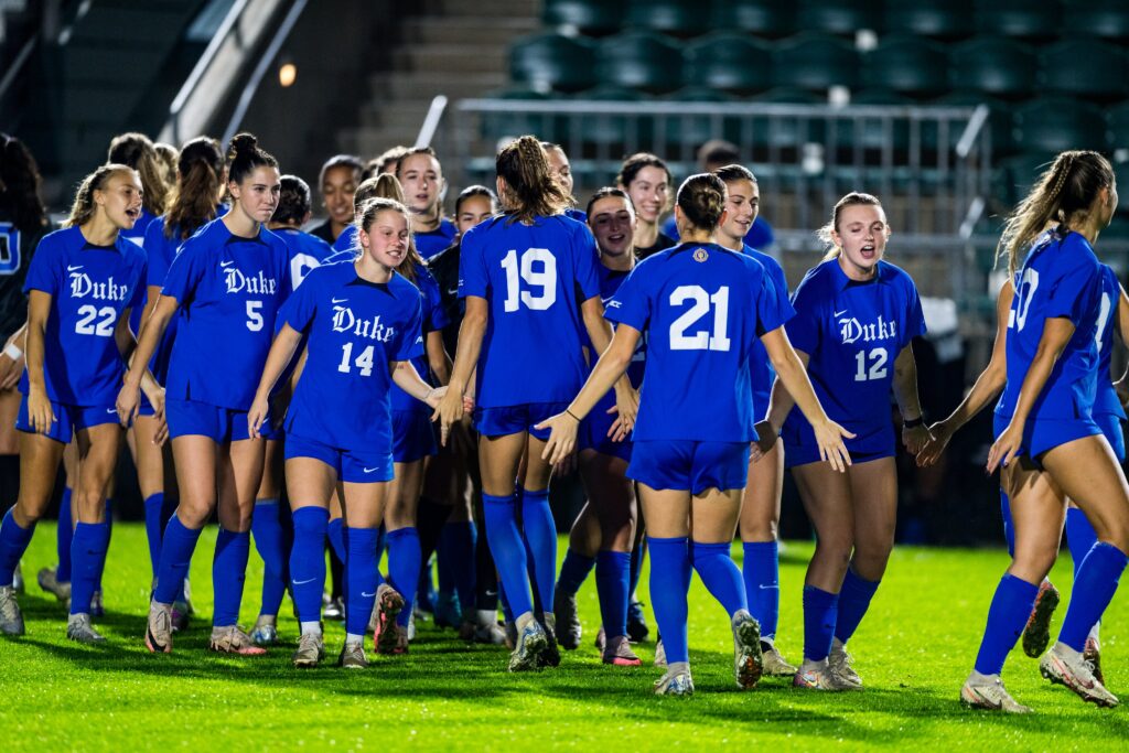 Duke college soccer players congratulate each other post-game.