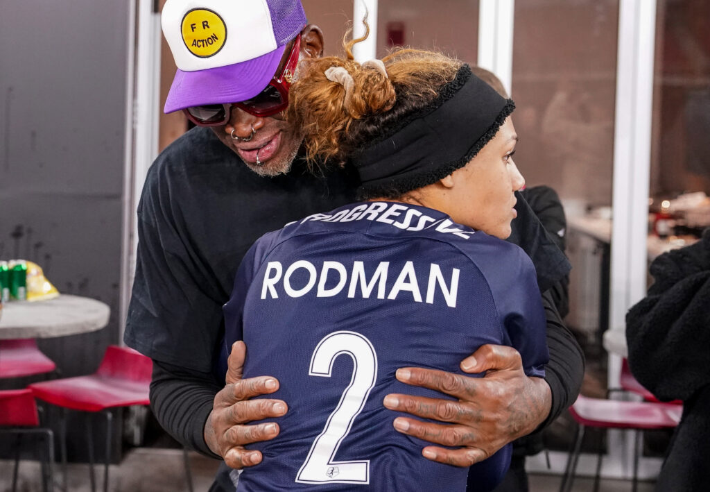 Dennis Rodman hugs his daughter, Washington's Trinity Rodman, after her 2021 NWSL quarterfinal.