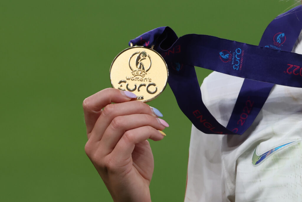 England's Chloe Kelly holds her 2022 Euro gold medal.