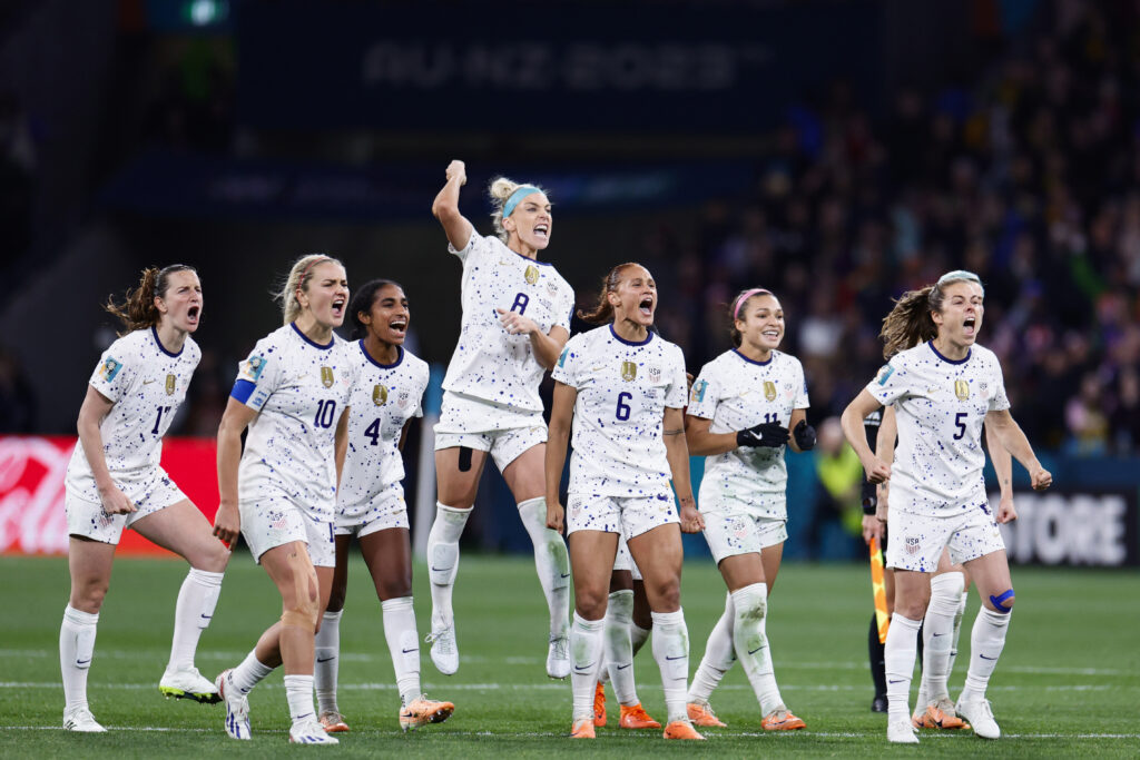 The USWNT celebrates a penalty goal  during the 2023 World Cup.