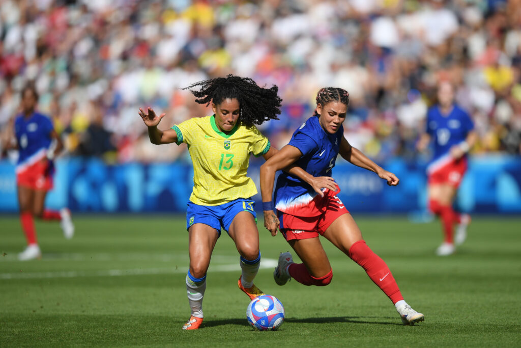 Brazil's Yazmim battles against USWNT forward Trinity Rodman for the ball.