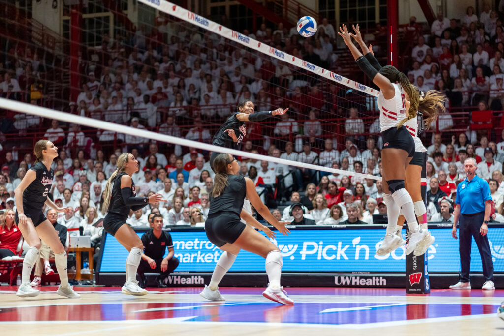 Nebraska's Taylor Landfair spikes the ball against NCAA volleyball conference rival Wisconsin.