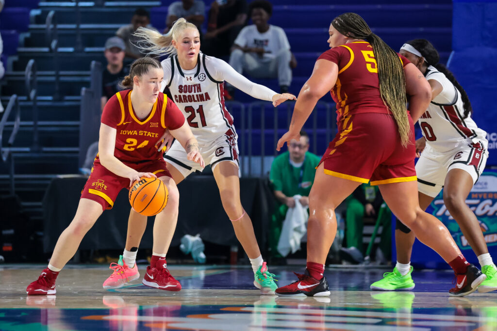 Iowa State's Addy Brown tries to dribble past South Carolina's defense.