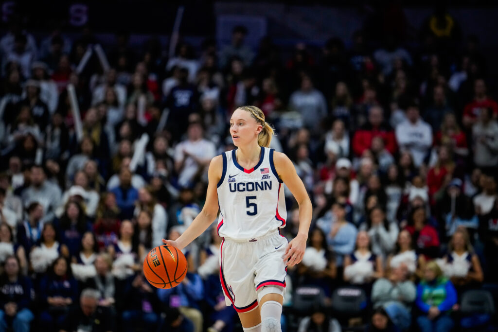 UConn star Paige Bueckers dribbles the ball up the court.