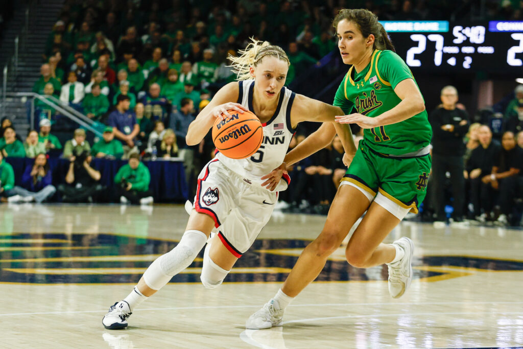 UConn's Paige Bueckers drives past Notre Dame's Sonia Citron during a game.