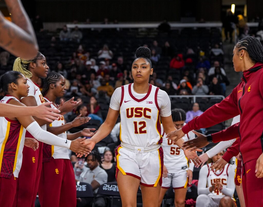 JuJu Watkins leads USC basketball onto the court for a game.