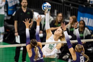 Mimi Colyer spikes the ball in Oregon's NCAA volleyball second-round win over TCU.