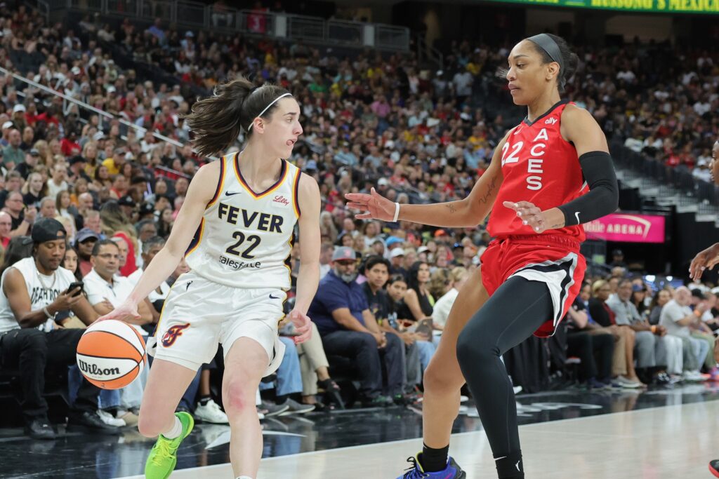 Las Vegas Aces star A'ja Wilson defends Indiana Fever standout Caitlin Clark during a WNBA game.