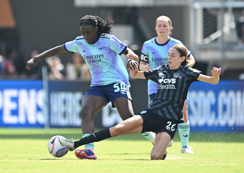 Arsenal's Michelle Aygemang dribbles around a Washington Spirit defender during an August 2024 NWSL friendly.