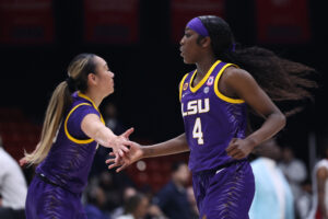 SEC basketball players Flau'jae Johnson and Last-Tear Poa of LSU high-five on the court