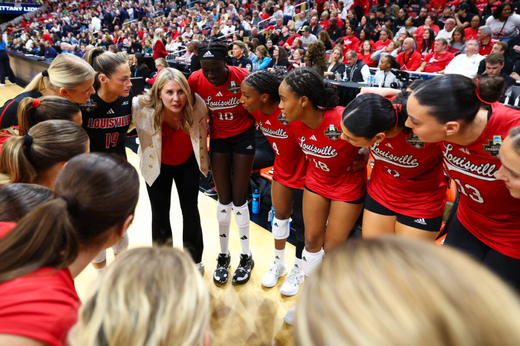 Former John Cook assistant at Nebraska Dani Busboom Kelly Head Coach of the Louisville Cardinals speaks with her team before the Division I Women's Volleyball Championship against the Penn St. Nittany Lions held at the KFC YUM! Center.