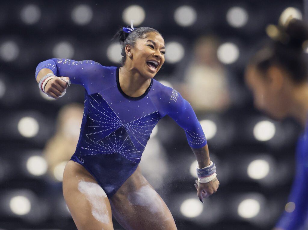 Jordan Chiles celebrates her bar routine at UCLA's first NCAA gymnastics meet of 2025.