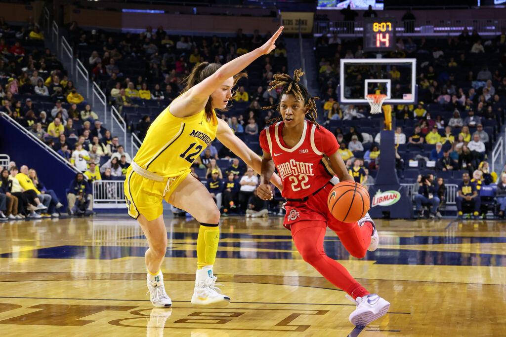 Michigan's Syla Swords defends Ohio State guard Jaloni Cambridge's drive to the basket during Wednesday's rivalry game.