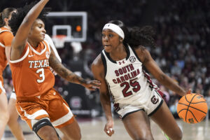 South Carolina's Raven Johnson dribbles against Texas's Rori Harmon during Sunday's NCAA basketball game.