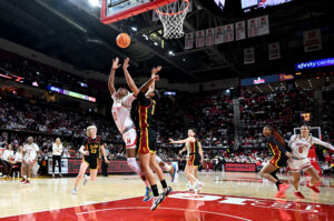 Maryland's Shyanne Sellers and USC's JuJu Watkins leap for the ball during Wednesday's NCAA basketball game.