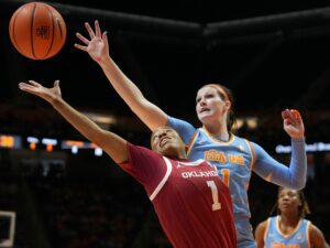 Tennessee's Sara Puckett and Oklahoma's Neveah Tot try to grab a rebound during a game.