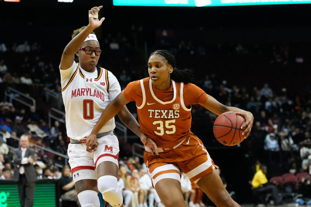 Texas's Madison Booker drives past Maryland's Shyanne Sellers during an NCAA basketball game.