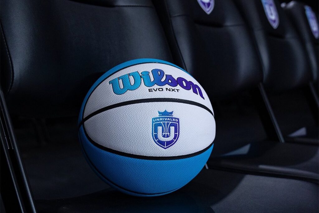 Unrivaled's official teal and white basketball rests on a black chair.