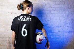 Emily Sonnett shows off the new Dove sponsorship above her last name on her Gotham jersey.