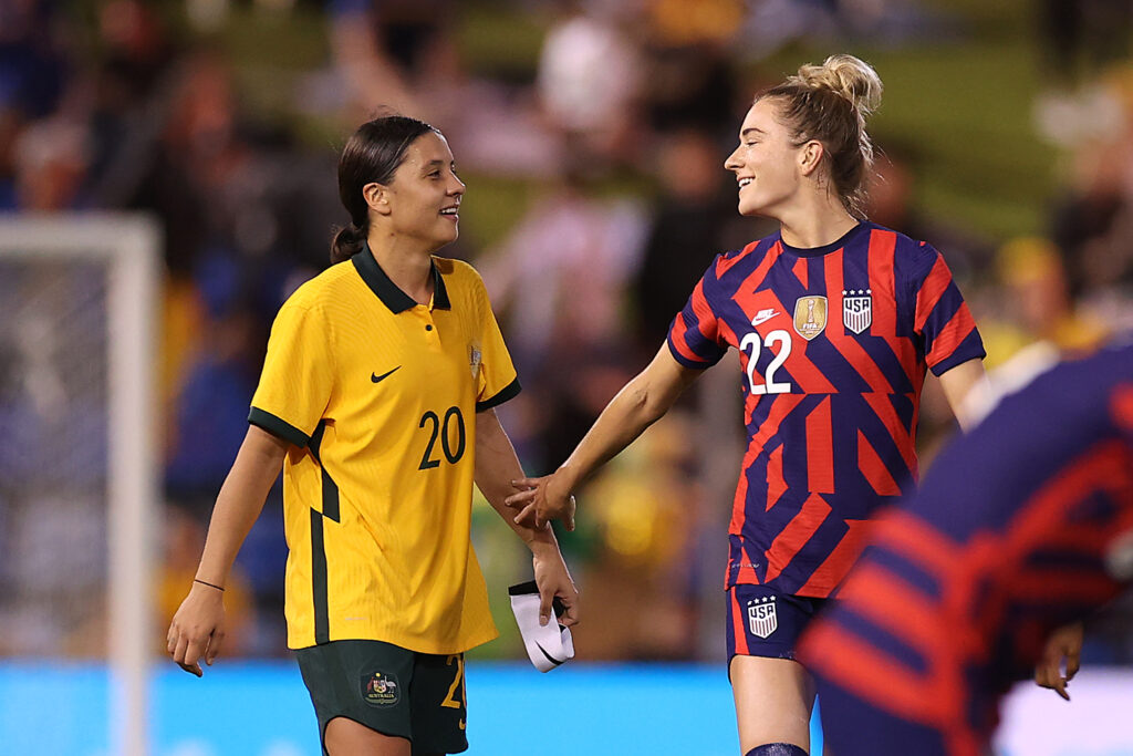 Australia captain Sam Kerr laughs with USWNT midfielder Kristie Mewis after a friendly.