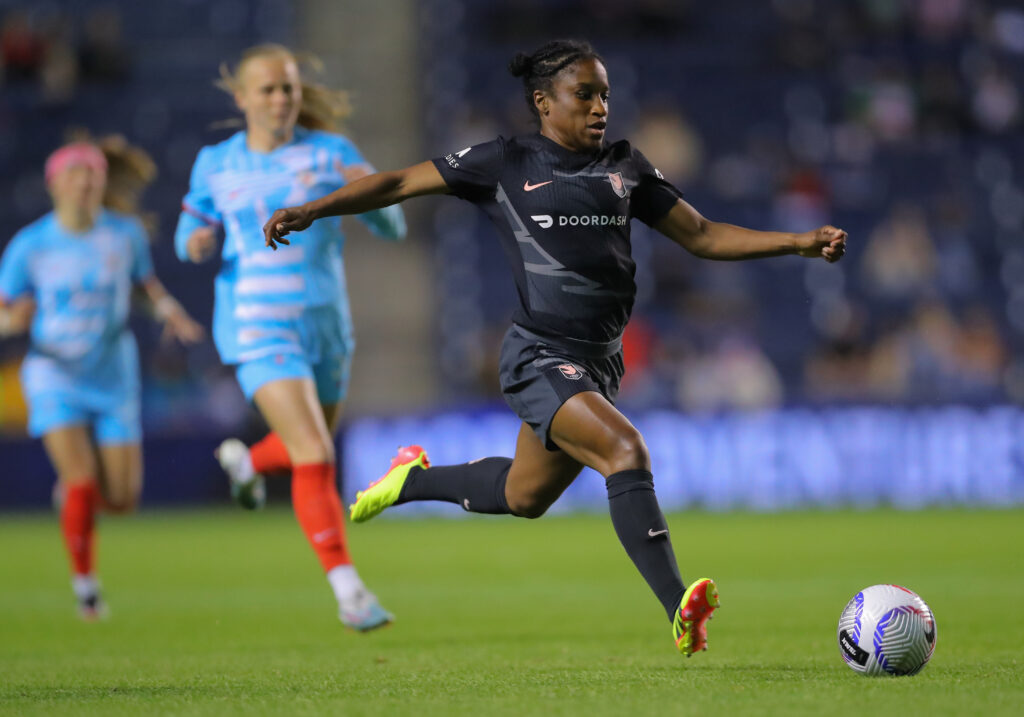 Angel City defender Jasmyne Spencer dribbles the ball up the pitch during a 2024 NWSL match against the Chicago Red Stars.