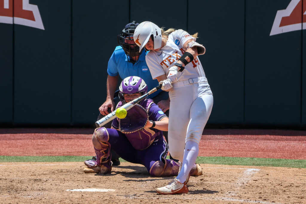 Texas star catcher Reese Atwood blasts a double during a 2024 NCAA Softball Regional game against Northwestern.