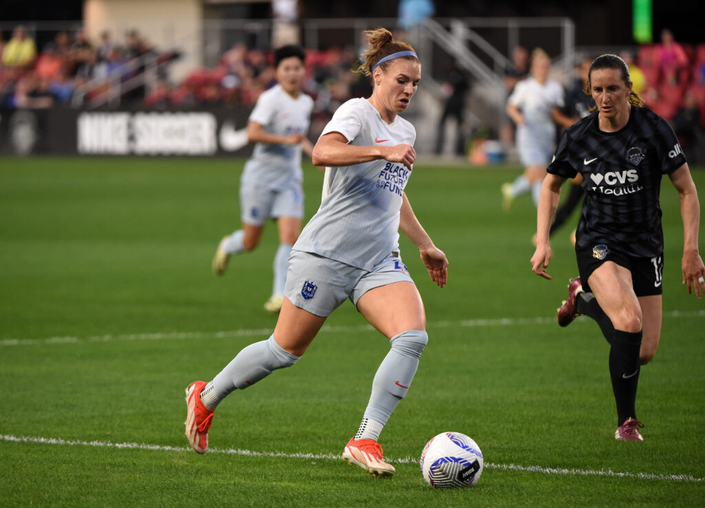 Seattle Reign's Veronica Latsko dribbles the ball during a 2024 NWSL match against the Washington Spirit.