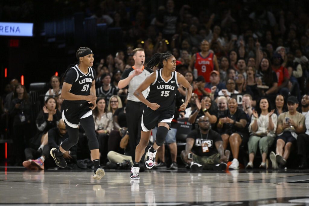 Las Vegas Aces standouts Sydney Colson and Tiffany Hayes race downcourt during a 2024 game.