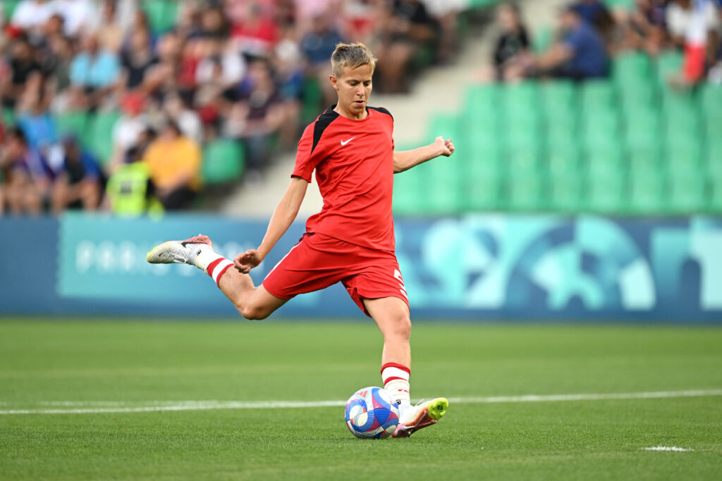 Team Canada's Quinn kicks the ball during a 2024 Olympic group-stage match against France.